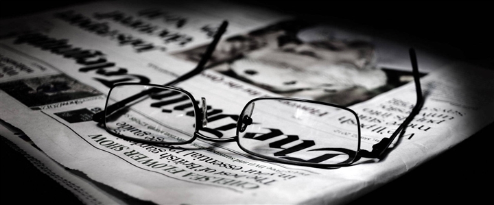 A pair of glasses on a newspaper